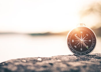 compass-of-tourists-on-mountain-at-sunset-sky-picture-id1044022268.jpg